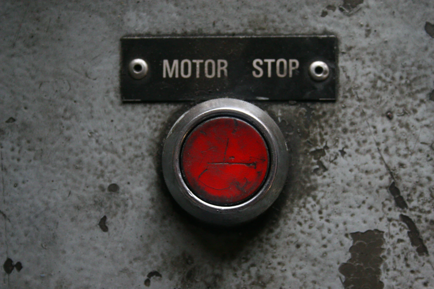 Red motor stop button on an industrial control panel